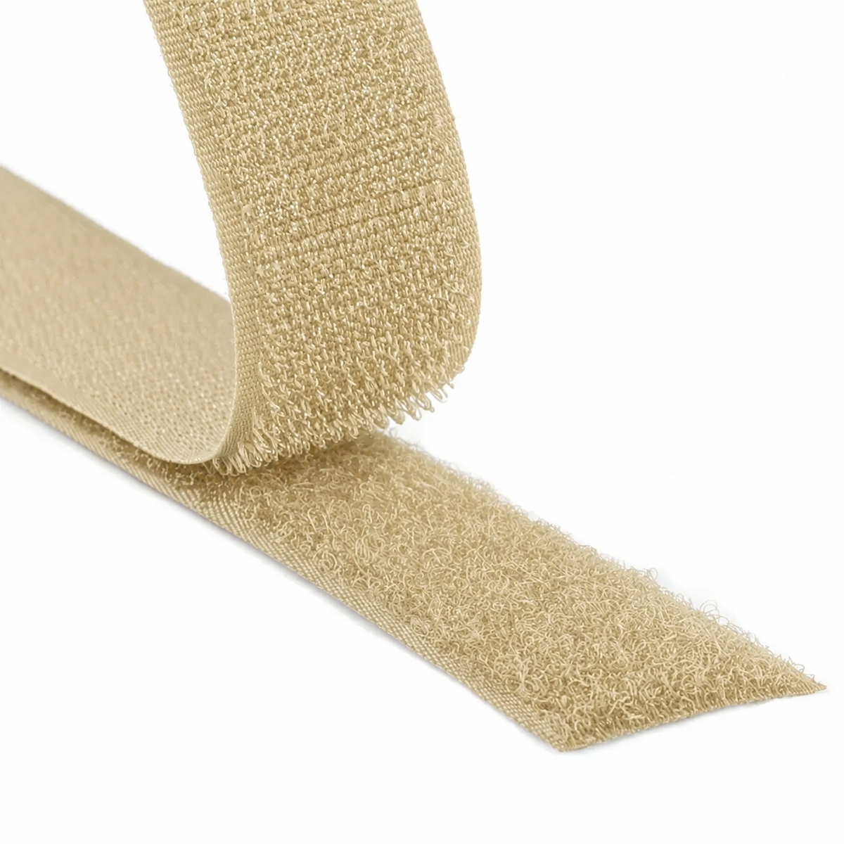 Close-up of a beige hook and loop fastener tape showing both hook and loop sides on a white background