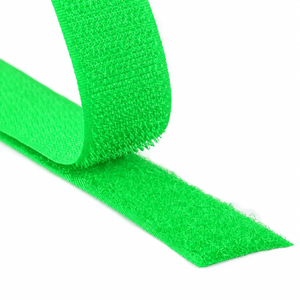 Close-up of a fluorescent green hook and loop fastener tape showing both hook and loop sides on a white background