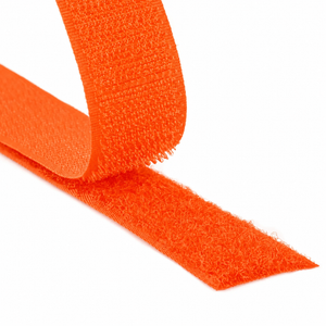 Close-up of a fluorescent orange hook and loop fastener tape showing both hook and loop sides on a white background
