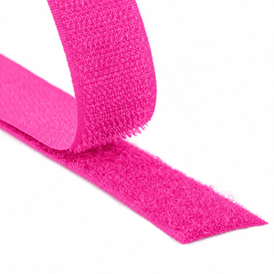 Close-up of a fluorescent pink hook and loop fastener tape showing both hook and loop sides on a white background