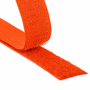 Close-up of a orange hook and loop fastener tape showing both hook and loop sides on a white background.