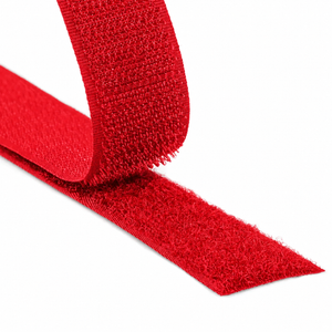 Close-up of a red hook and loop fastener tape showing both hook and loop sides on a white background